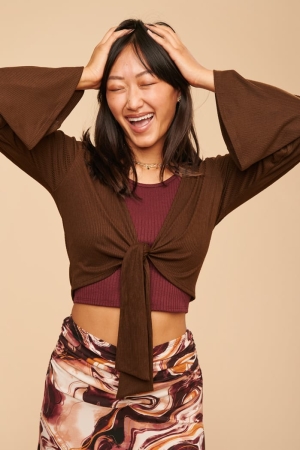 Coco Long Sleeve Hooded Crop Top front view with models arms up 