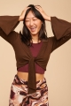 Coco Long Sleeve Hooded Crop Top front view with models arms up 