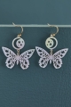 White Cut Out Butterfly Earrings laid out