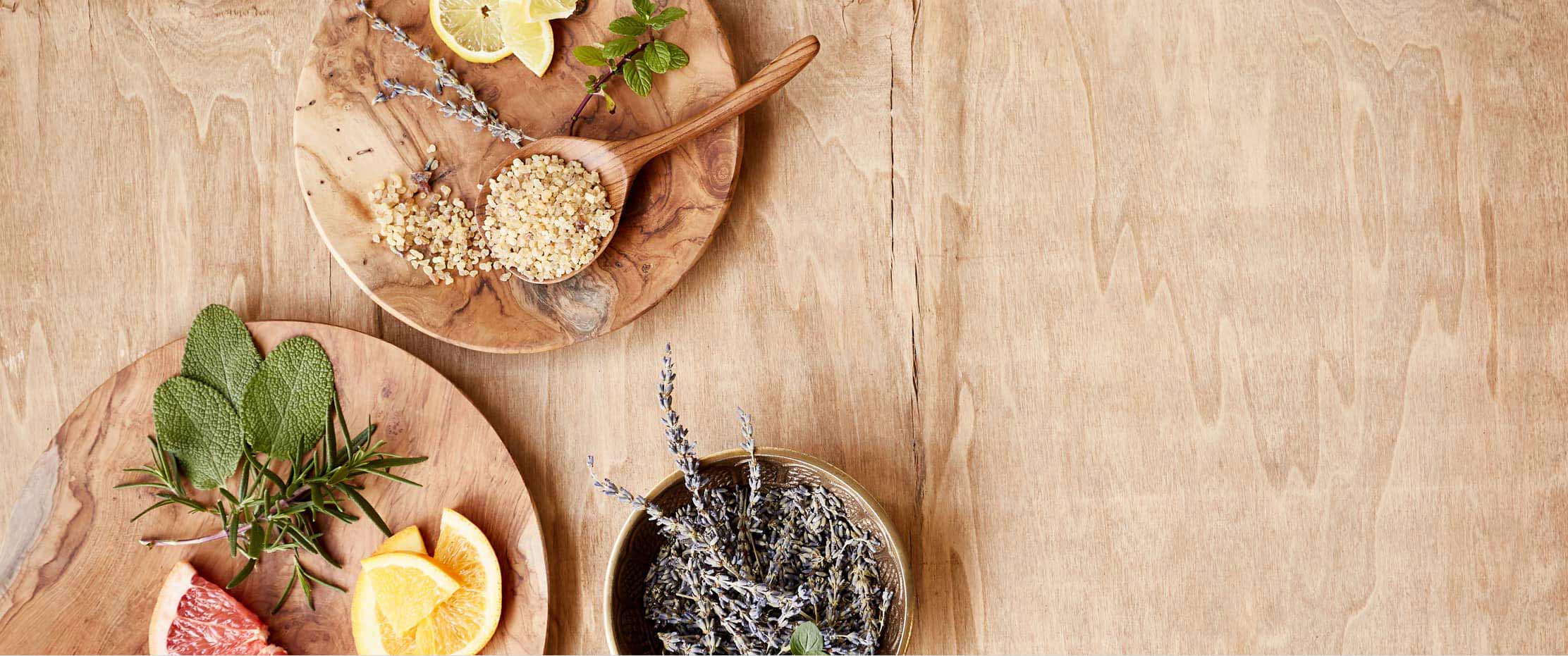 Wooden table with bowls of herbs