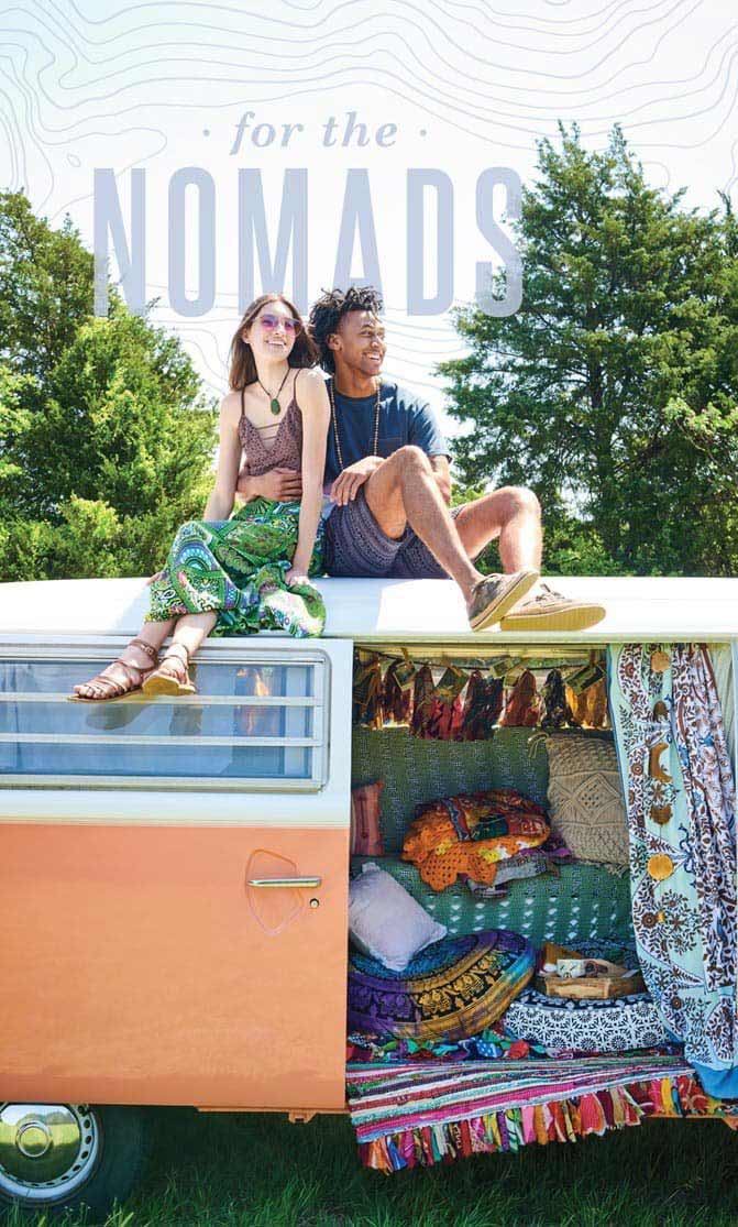 Nomadic girl and guy sitting on top of bohemian decorated hippie van. Reads: For the nomads